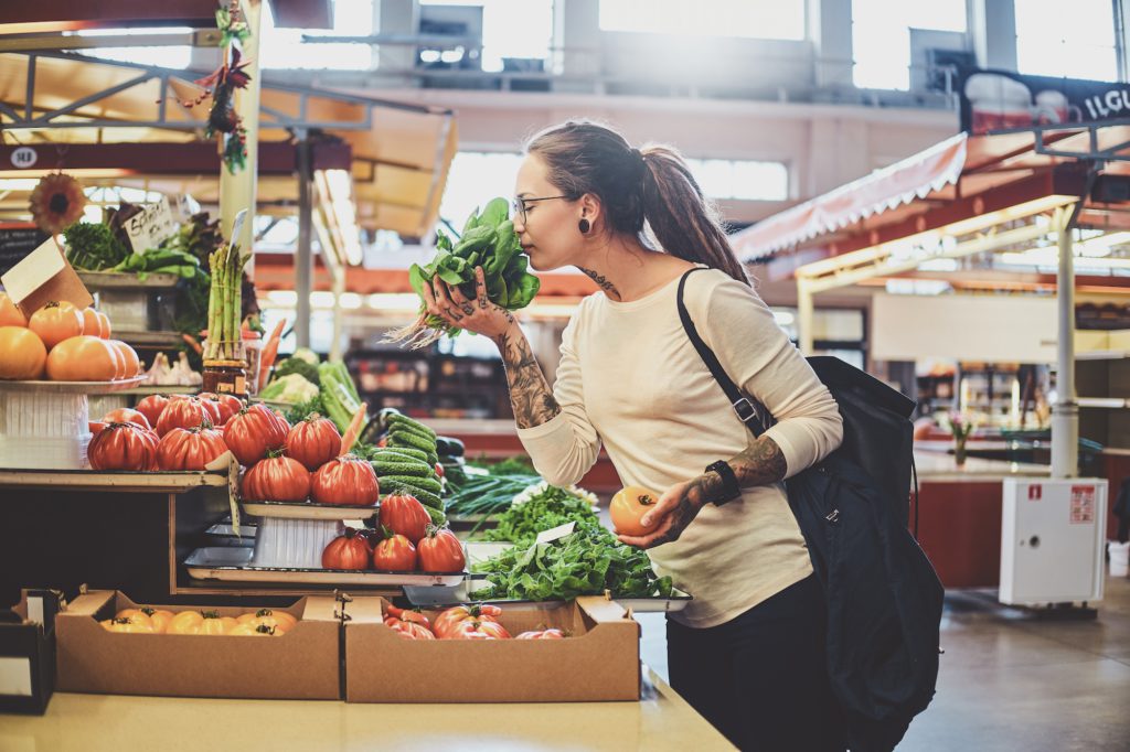 tattooed-young-lady-is-choosing-sesonal-vegetables-ZB9FK3M-1024x682