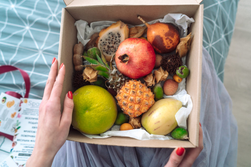 Box of fruit from someone in the hands, a close angle