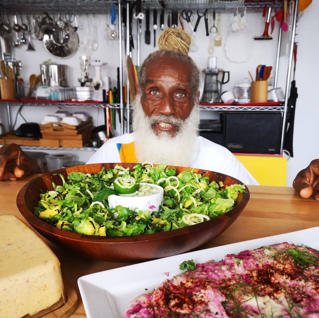 Aris LaTham in his kitchen with fresh food